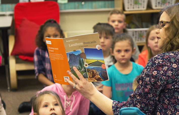 Teacher reading to classroom of students