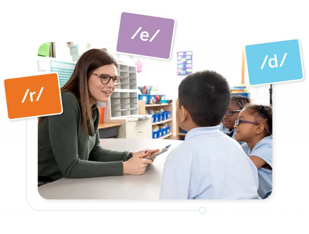 A teacher using a tablet discusses with three young students at a desk in a classroom, highlighted by speech sound symbols.