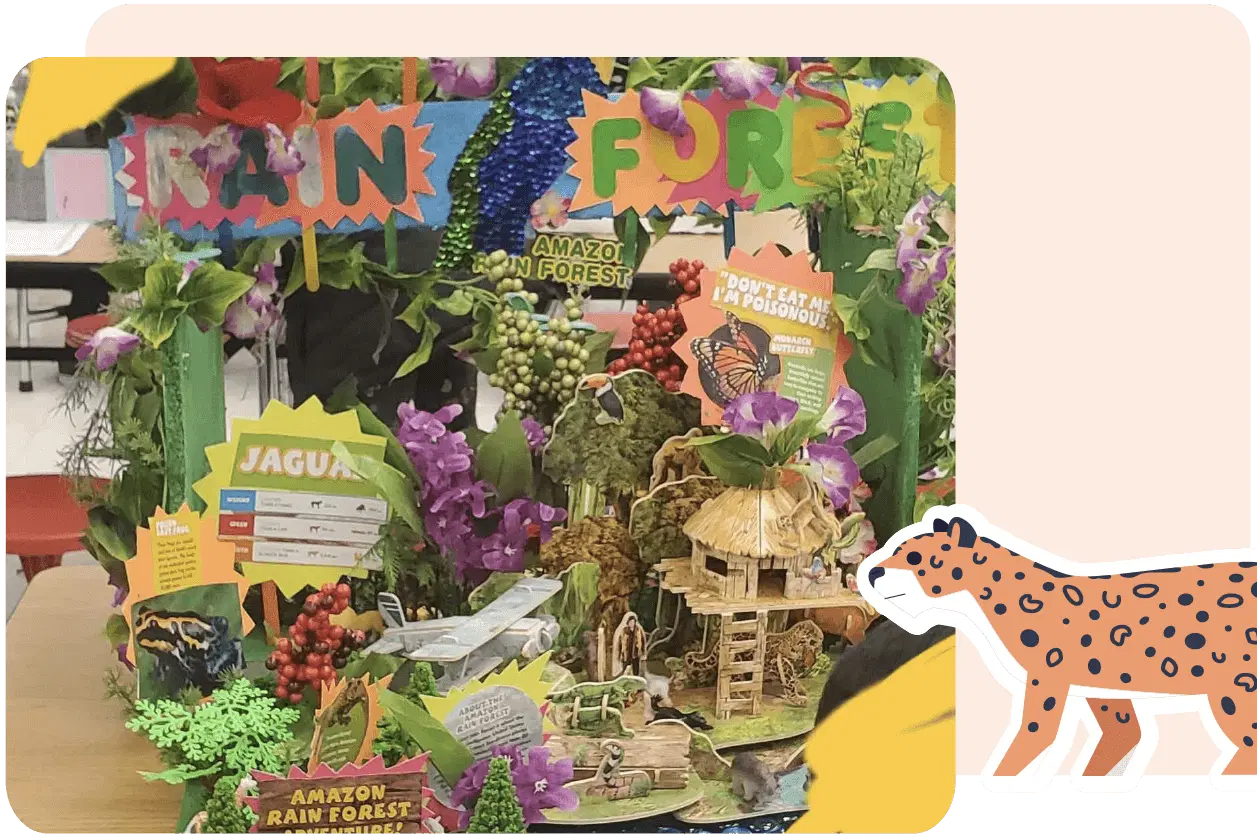 Colorful diorama depicting the Amazon rainforest, featuring plants, animal facts, a jaguar illustration, and educational signs about the ecosystem.
