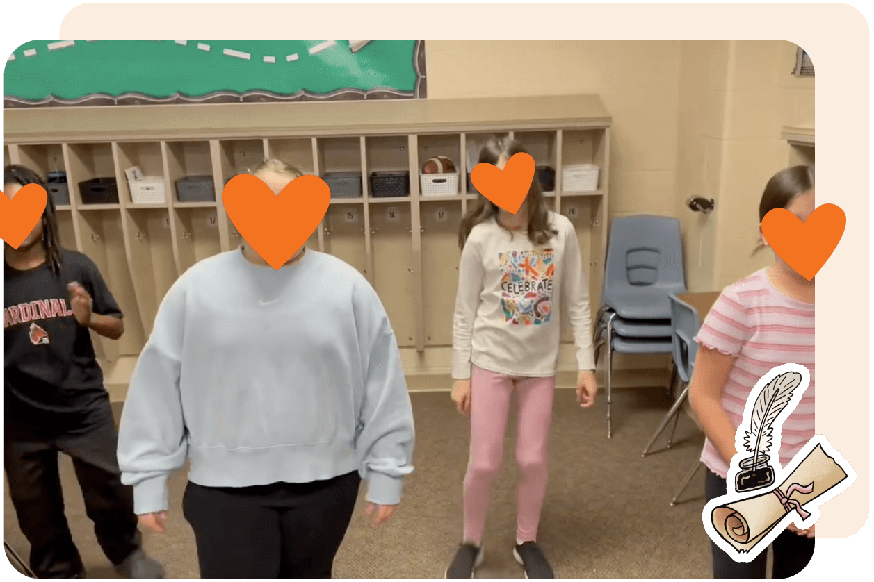 Four children with heart stickers on their faces stand in a classroom with cubbies and chairs in the background.