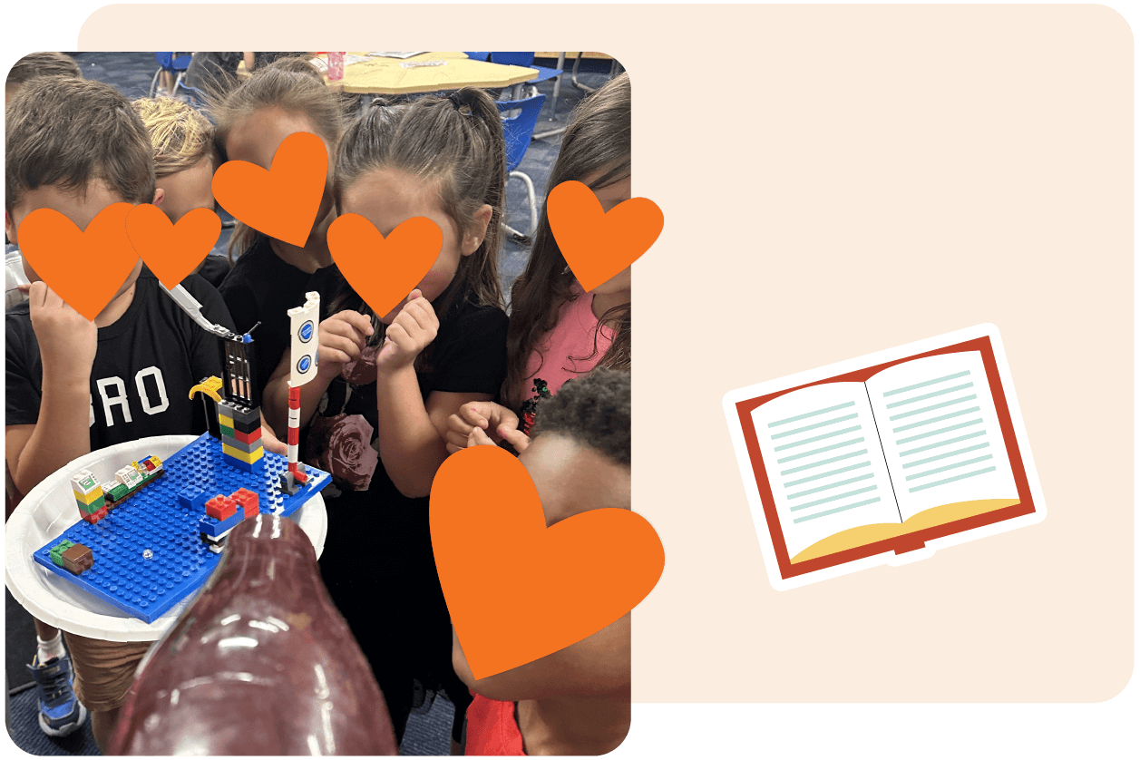Children gathered around a LEGO rocket model on a blue baseplate; orange hearts cover their faces. An illustration of an open book is on the right side of the image.