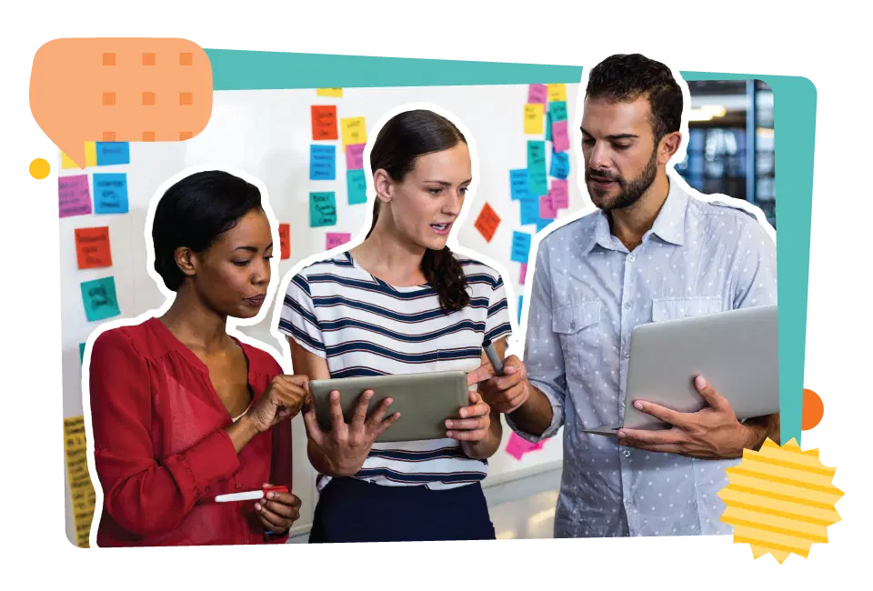 Three people collaborating with tablets in front of a whiteboard covered in colorful sticky notes.