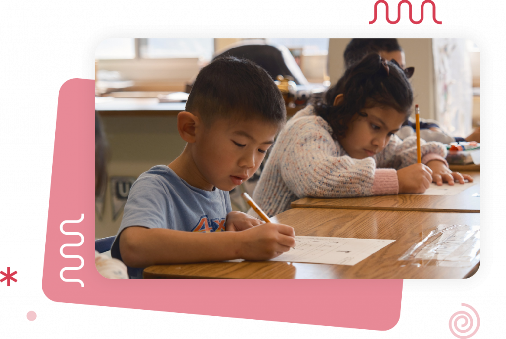 Two children focus on their studies while writing at their desks in a classroom, benefiting from teacher resources aligned with the CKLA curriculum.