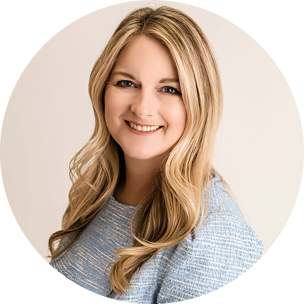 A smiling person with long blonde hair wears a textured blue top against a plain background, embodying the essence of personalized learning.