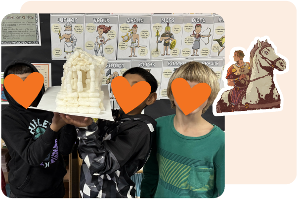 Three children hold a model of an ancient Greek temple in front of a classroom display about Roman gods with educational posters, using Amplify CKLA resources for teachers. Faces are covered with orange heart shapes.
