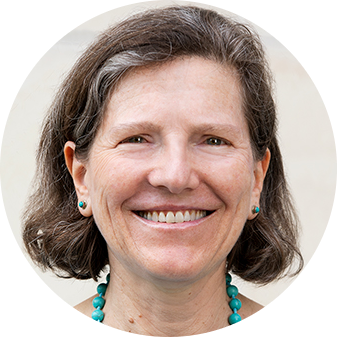 A middle-aged woman with short gray hair and a warm smile, wearing turquoise earrings and a matching necklace, hosts a Science of Reading podcast against a light background.