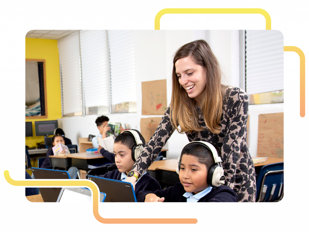 A teacher assists students wearing headphones as they work on laptops, using mCLASS Math for math progress monitoring in a classroom setting.