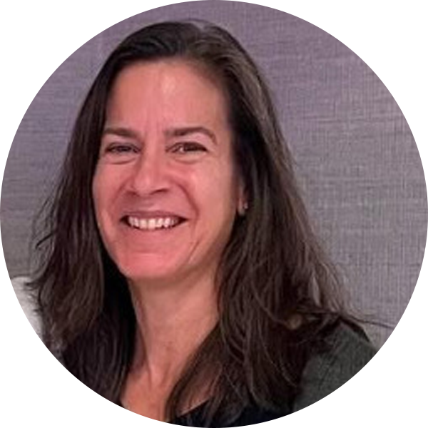 A woman with long dark hair, smiling and wearing a dark top, embodies the essence of individualized instruction against a neutral background.