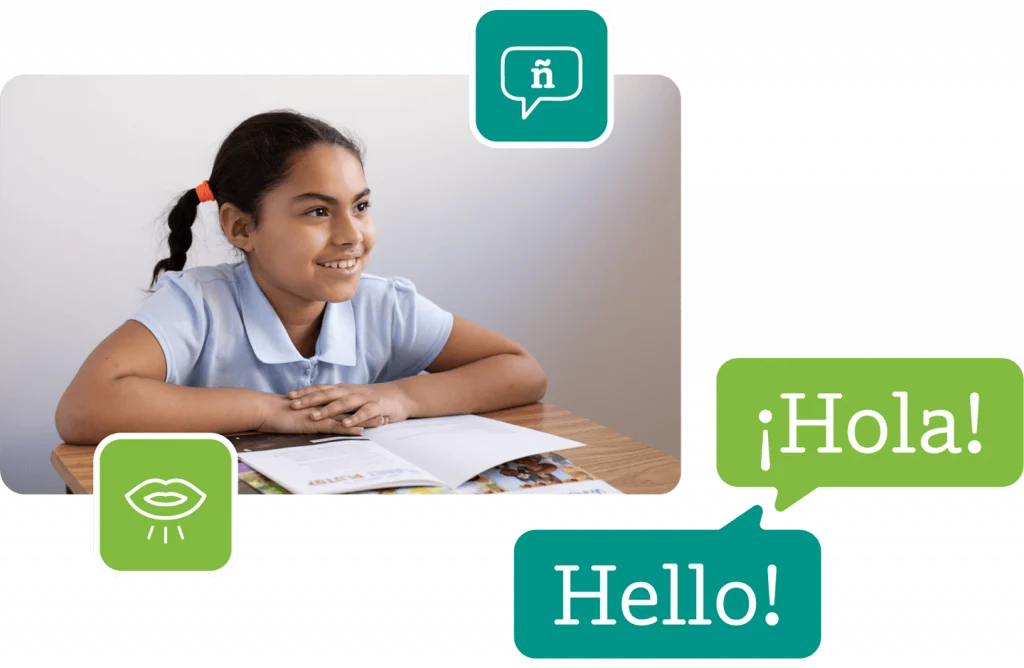 Young girl in a school uniform smiles while sitting at a desk with a book, speech bubbles saying "hello" in english and spanish above her.